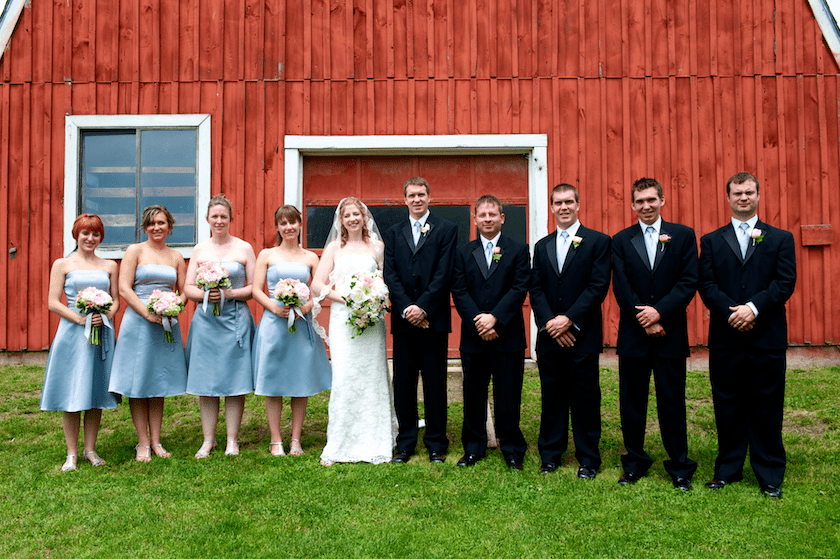 bridal party in front of barn at wedding
