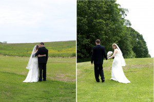 couple walk in field after wedding