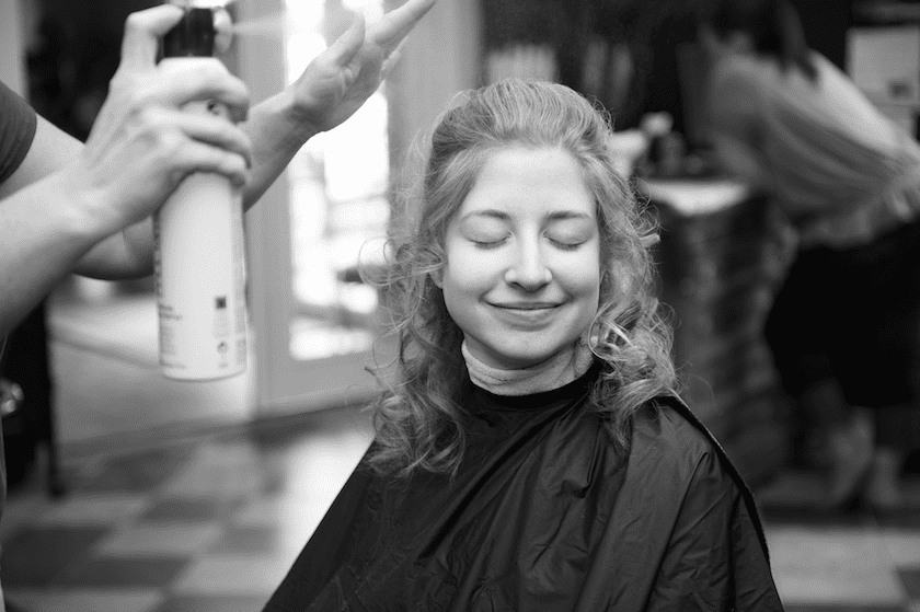 bride getting hair done before wedding