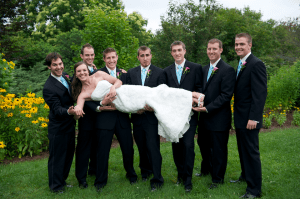 groomsmen carry Maine bride