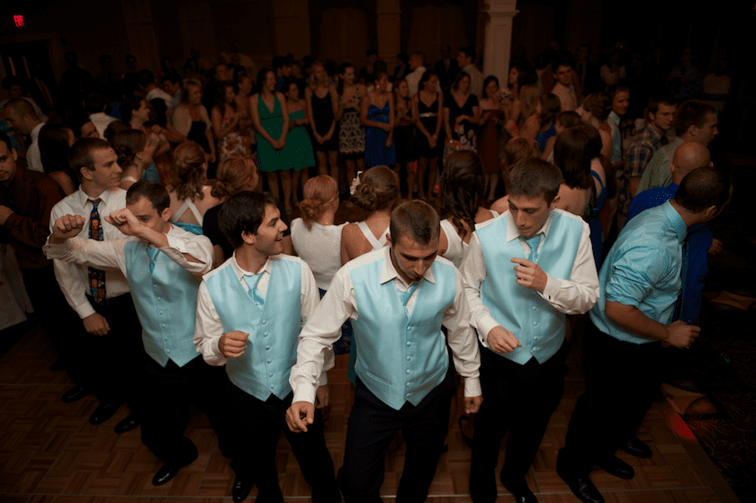 groomsmen play game at reception for garder