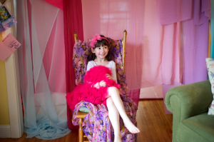 child sitting in her birthday throne