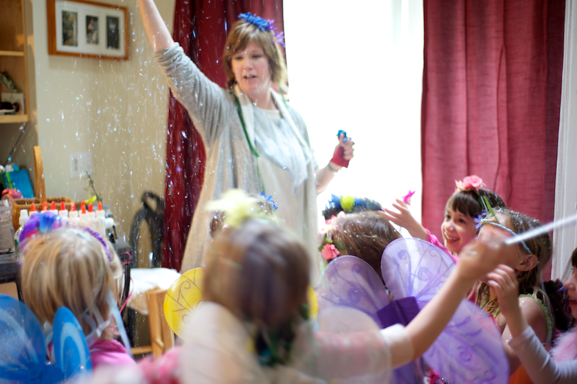 mother sprinkles fairy dust on the children