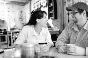 Maine bride and groom drink coffee at camp