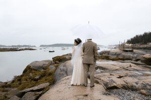 bride looks to the side while sharing umbrella