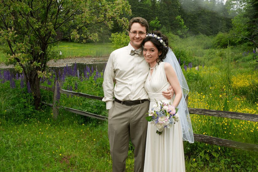 portrait near fence and wild flowers