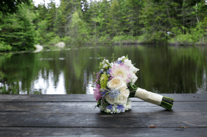 bouquet on picnic table at pond