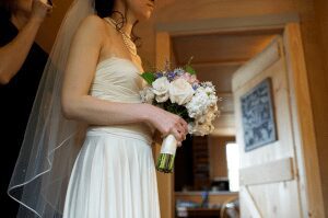 bride finishes hair and veil