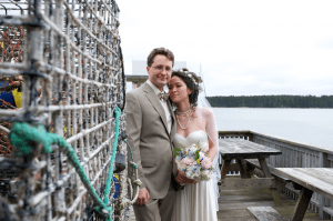 bride and groom on dock with lobster traps