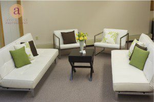 white couches with yellow floral arrangement