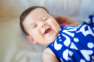 baby laughing on couch