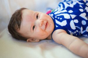 baby smiles on the couch