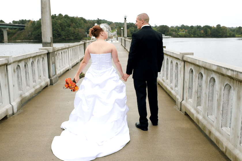 Maine wedding bride and groom take walk on bridge