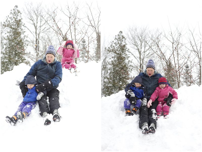 sliding down the hill with grandpa for winter family photos in Maine