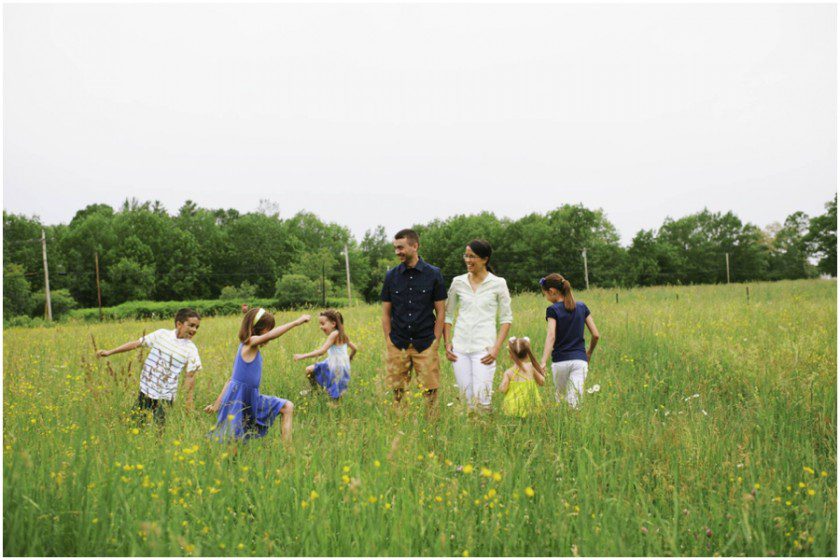 family photos of kids running in a field of buttercups