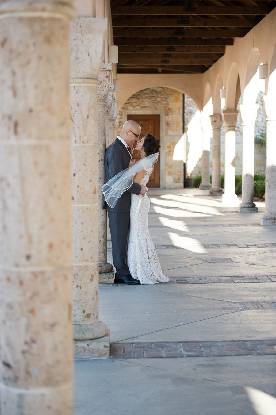 A candid moment shared between a bride and her groom captured by Houston wedding photographer, Anne Schmidt.
