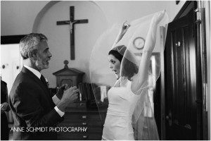 bride lifts veil for father before wedding